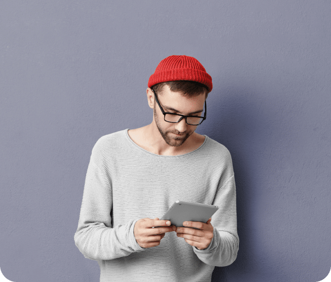 Person holding a tablet in a grey background